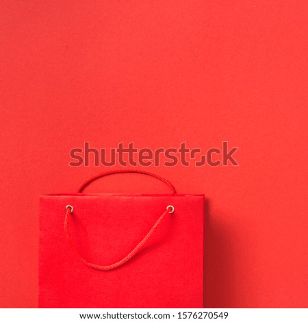 Empty red paper bag on red background top view
