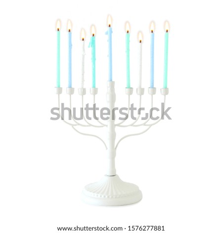 religion image of jewish holiday Hanukkah with white menorah (traditional candelabra) and colorful candles isolated over white background