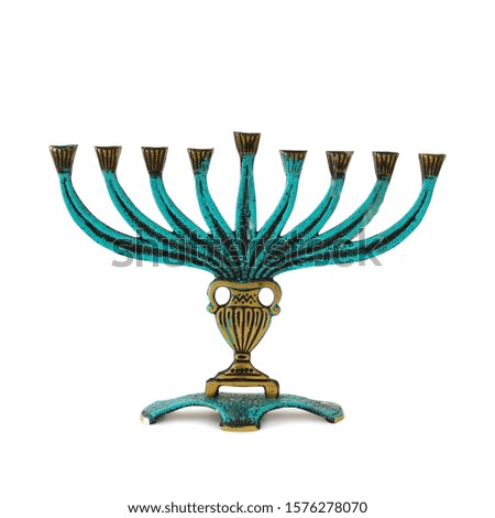 religion image of jewish holiday Hanukkah with brass menorah (traditional candelabra) isolated over white background