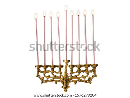 religion image of jewish holiday Hanukkah with brass gold menorah (traditional candelabra) and candles isolated over white background
