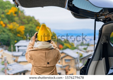 Woman traveller enjoy taking photo the scenery view of autumn village in Japan countryside, Travel all around Japan countryside by car transportation