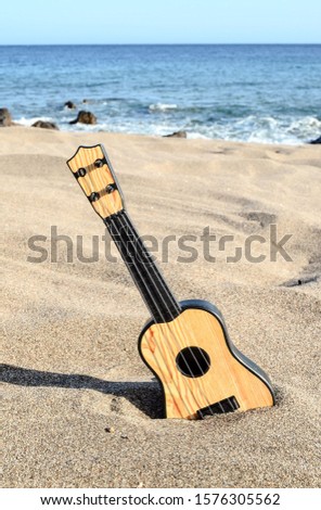 Photo Picture of a Guitar on the Sand Beach