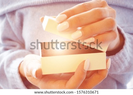Women hands hold and open white giftbox. Holiday concept.