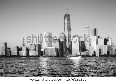 Black and white picture of New York City skyline at sunset, USA.