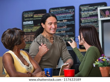 Pretty women ordering from server at a cafe
