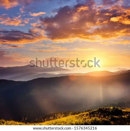 Alpine mountains are illuminated by the sunset. Picture of colorful cloudy sky. Location place of Carpathian national park, Ukraine, Europe. Splendid natural wallpaper. Discover the beauty of earth.