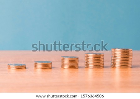stacks of coins, graphics and copy space on top