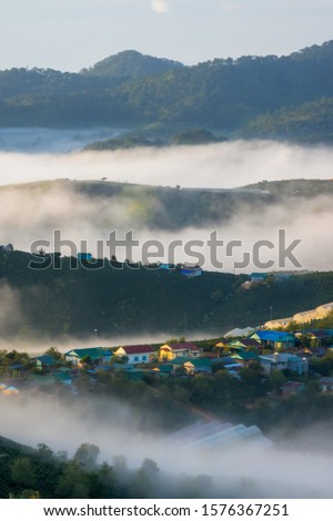 best experience and tourist in Dalat city, Vietnam at southeast asia. Beautiful village appear and disappear in the fog at sunrise with peaceful life, hospitality and relaxing