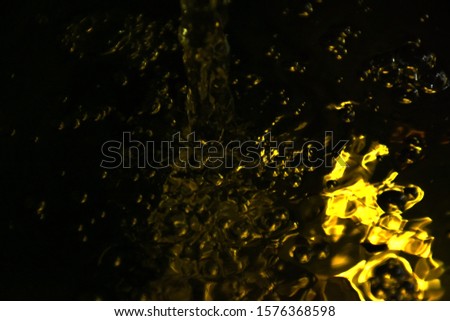 Golden water and bubbles in the aquarium