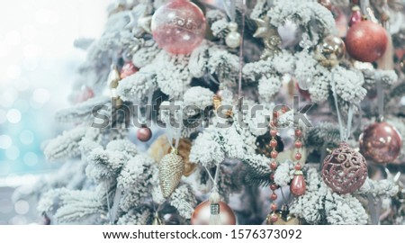 Closeup of pine branch with decorations. Christmas and New Year holiday background. Vintage color tone. Copy space for your text.