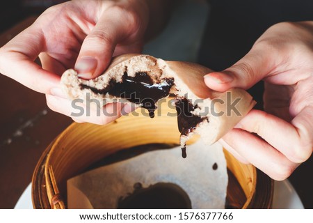 Chinese steamed bun and chocolate sweet creamy lava on chinese pattern dish. Dimsum Chinese famous food. 