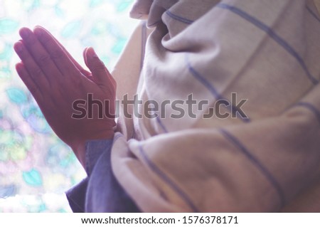 Hands of men are praying at the church, Out of focus.