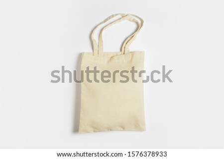 Bright linen bag for shopping on a white background. Eco material. Shopping concept, place for logo. Flat lay, top view