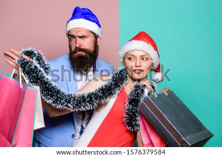 time for presents. happy new year party. gift with love. time for presents. happy family couple on xmas. santa man and woman with tinsel. christmas shopping sales. winter holidays celebrate together.