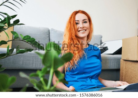 Young woman moving in to new apartment