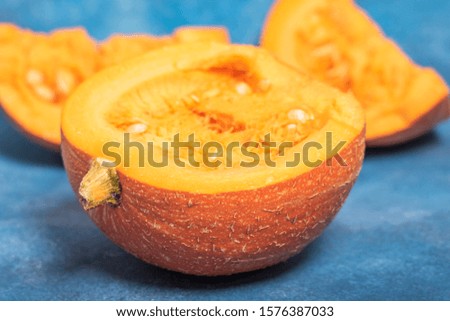chopped large pumpkin on a blue background