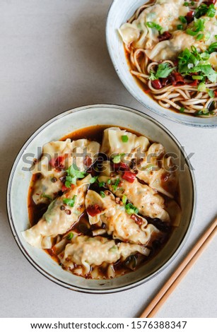 Homemade chinese cuisine / Jiaozi Dumplings in Sichuan Mala Gravy or Noodle / Tasty and savory with spicy and tongue numbing sensation. Dumplings wrapped with ground pork and shrimp and water chestnut