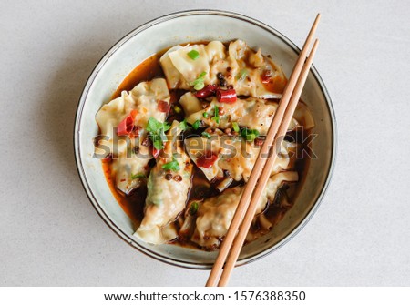 Homemade chinese cuisine / Jiaozi Dumplings in Sichuan Mala Gravy or Noodle / Tasty and savory with spicy and tongue numbing sensation. Dumplings wrapped with ground pork and shrimp and water chestnut