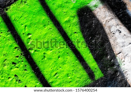Fragment of colored graffiti painted on a concrete wall. Bright abstract background for design.