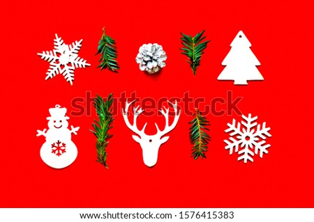 Christmas pattern of wooden decorations on red background. Zero waste Christmas concept. Copy space, close-up