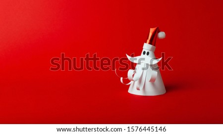Homemade paper figure of Santa Claus on red background. Christmas art, banner for celebrate.