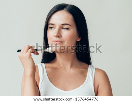 Makeup woman brush healthy natural skin applying make up powder