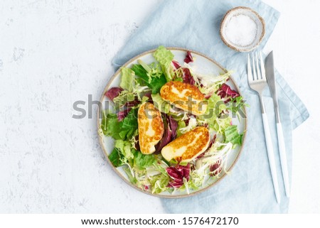 Cyprus fried halloumi with healthy salad. Lchf, pegan, fodmap, paleo, scd, keto, ketogenic diet. Balanced food, clean eating recipe. Top view, copy space, white background