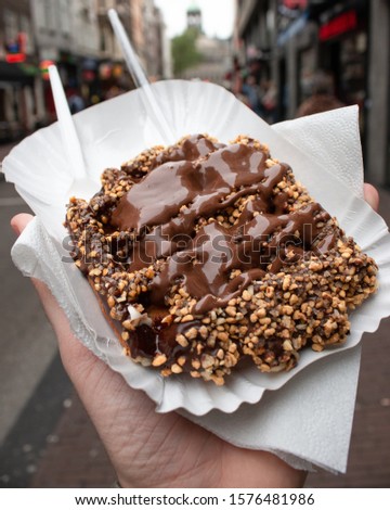 A chocolate and nut coated waffle on the narrow, buzzing streets of Amsterdam 