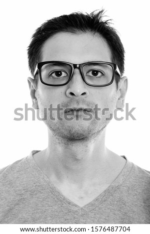 Face of young man with eyeglasses looking at camera