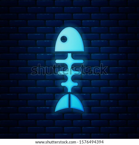 Glowing neon Fish skeleton icon isolated on brick wall background. Fish bone sign.  Vector Illustration