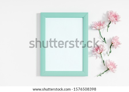 Beautiful flowers composition. Photo frame and pink flowers on white background. Valentines Day, Easter, Happy Women's Day, Mother's day. Flat lay, top view, copy space