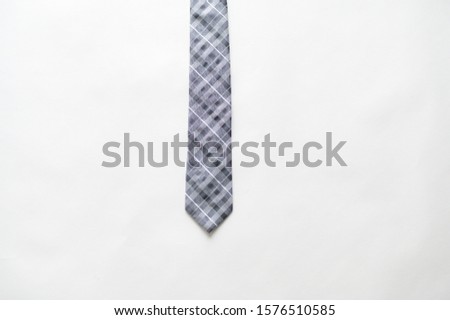 An overhead shot of a striped tie on a white surface