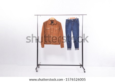 brown jeans jacket clothes with blue jeans on hanging background


