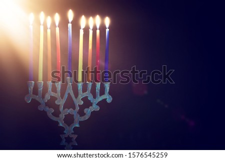 Religion image of jewish holiday Hanukkah background with menorah (traditional candelabra) and colorful candles