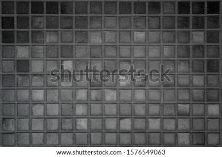 Black the tile wall high resolution real photo or brick seamless and texture interior background. Dark tiles wall texture for the decoration of the bedroom. 2