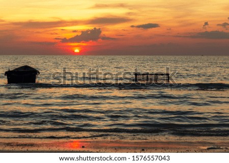 Silhouette of  Fishing boat and Fishing equipment. Sunset and Fishing boat at Sea rayong,Thailand.