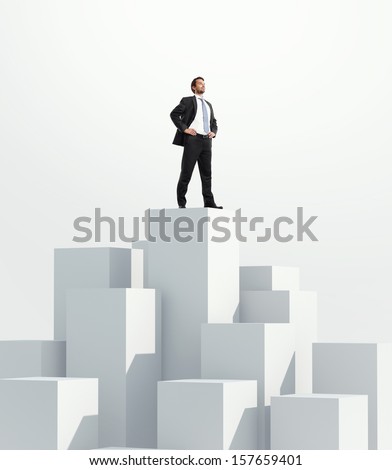Man standing on highest cube. White background.