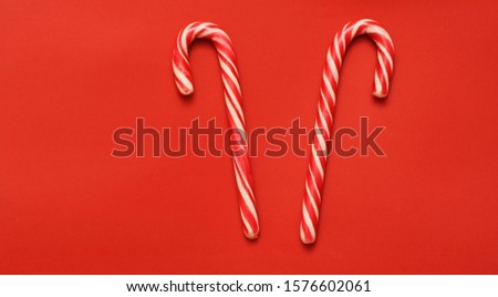 Christmas candies on red color background.