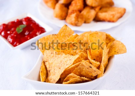 Selective focus on the front tortilla chips in white bowl