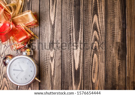 clock Christmas gifts on wooden background