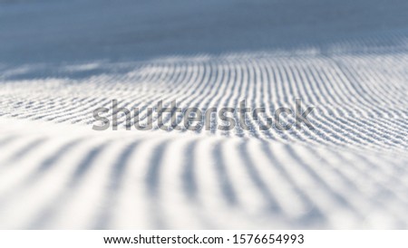 Close view of lines on groomed ski slope