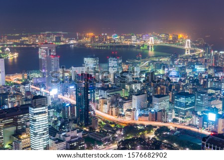 Tokyo, Japan over Tokyo Bay at night. Royalty-Free Stock Photo #1576682902