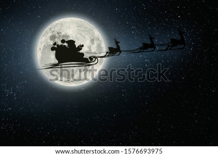 silhouette of a flying goth santa claus against the background of the night sky. Elements of this image furnished by NASA