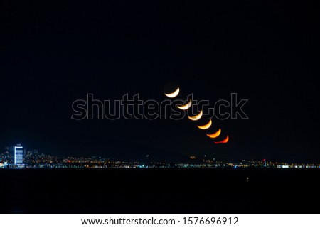 Moon set over city at night. Different moments of moon set on the same frame. Phases of the moon.