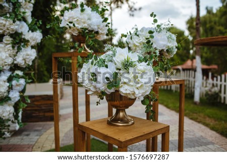 Decor for events from natural flowers, white orchid and wooden elements.
