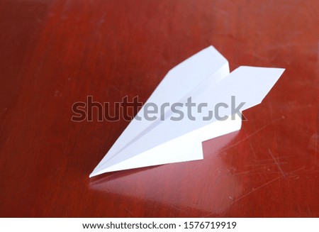 origami paper rocket on wood background