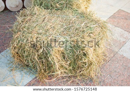 hay briquettes on stone floor background