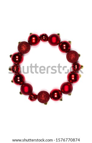 Round frame in form of Christmas wreath of New Year's red balls. Layout for design flat lay, place for text. Christmas balls of different sizes and textures. Merry Christmas and a happy new year.