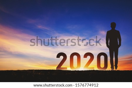 New year 2020 concept, Silhouette young success business man with sky at sunset