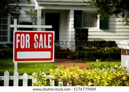 For sale sign outside a family house Royalty-Free Stock Photo #1576779889
